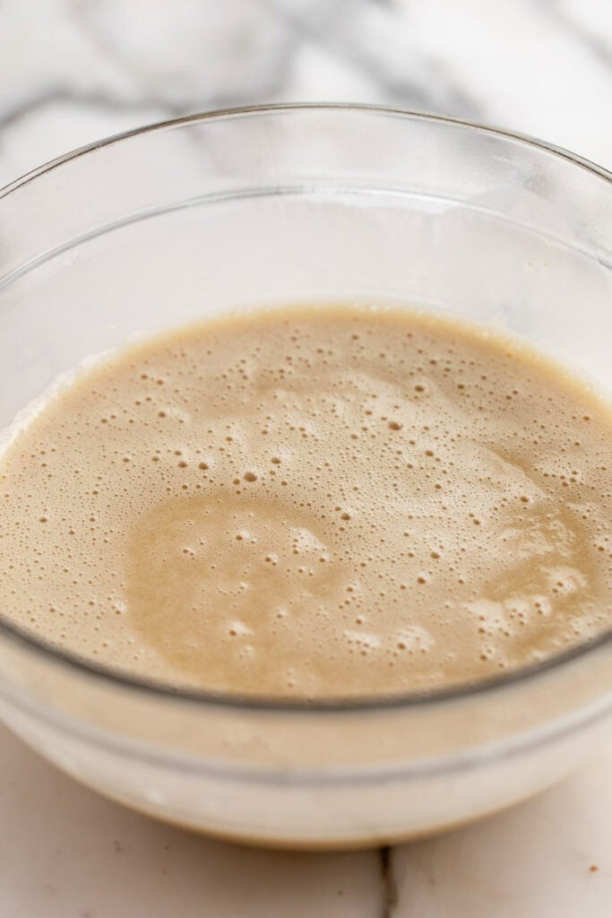 maple custard with eggs whisked in glass bowl.