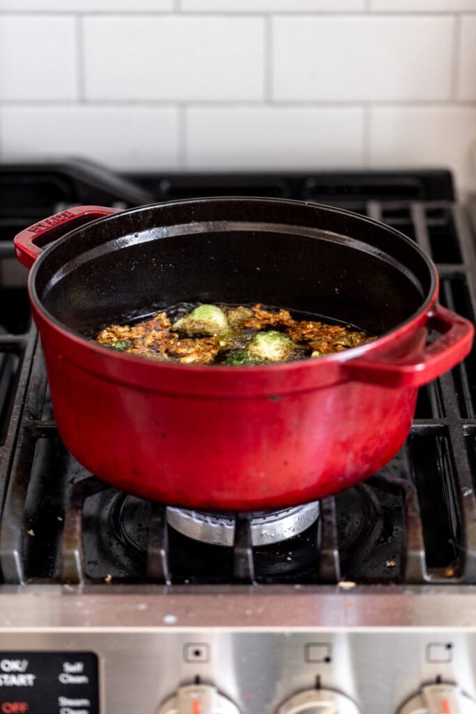 fried brussels sprouts in pot on stove.