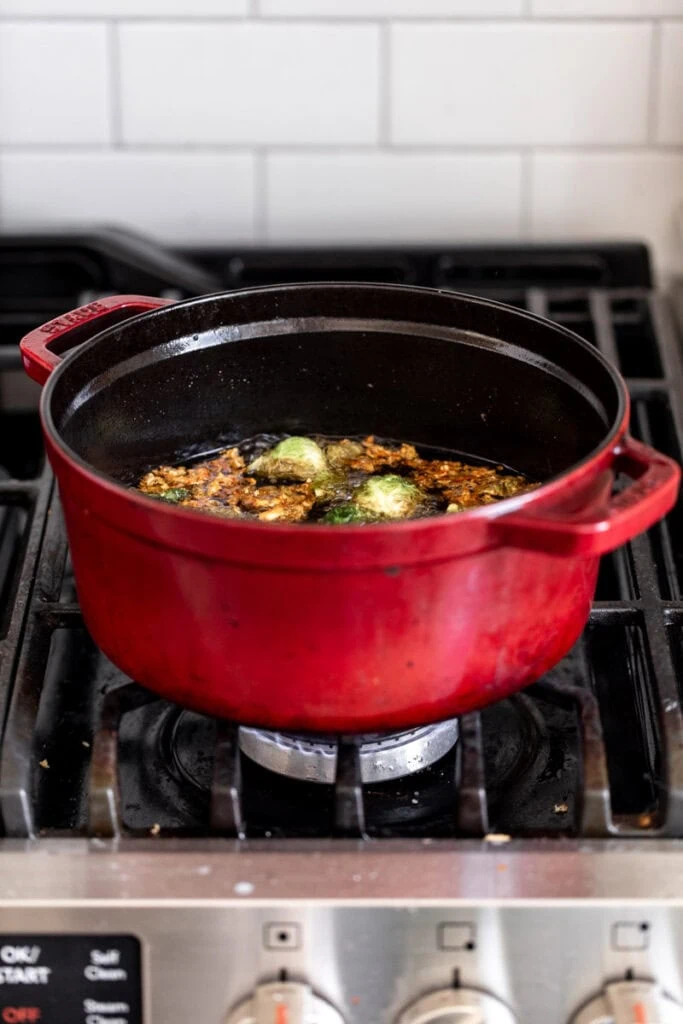 fried brussels sprouts in pot on stove.