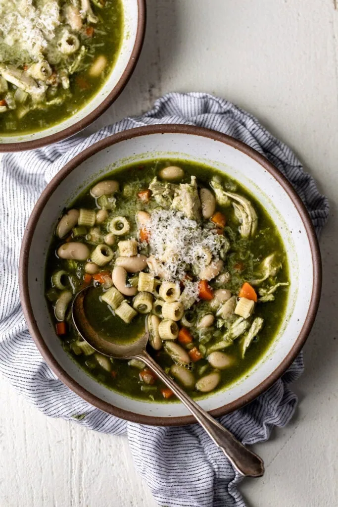 bowls of green minestrone soup;