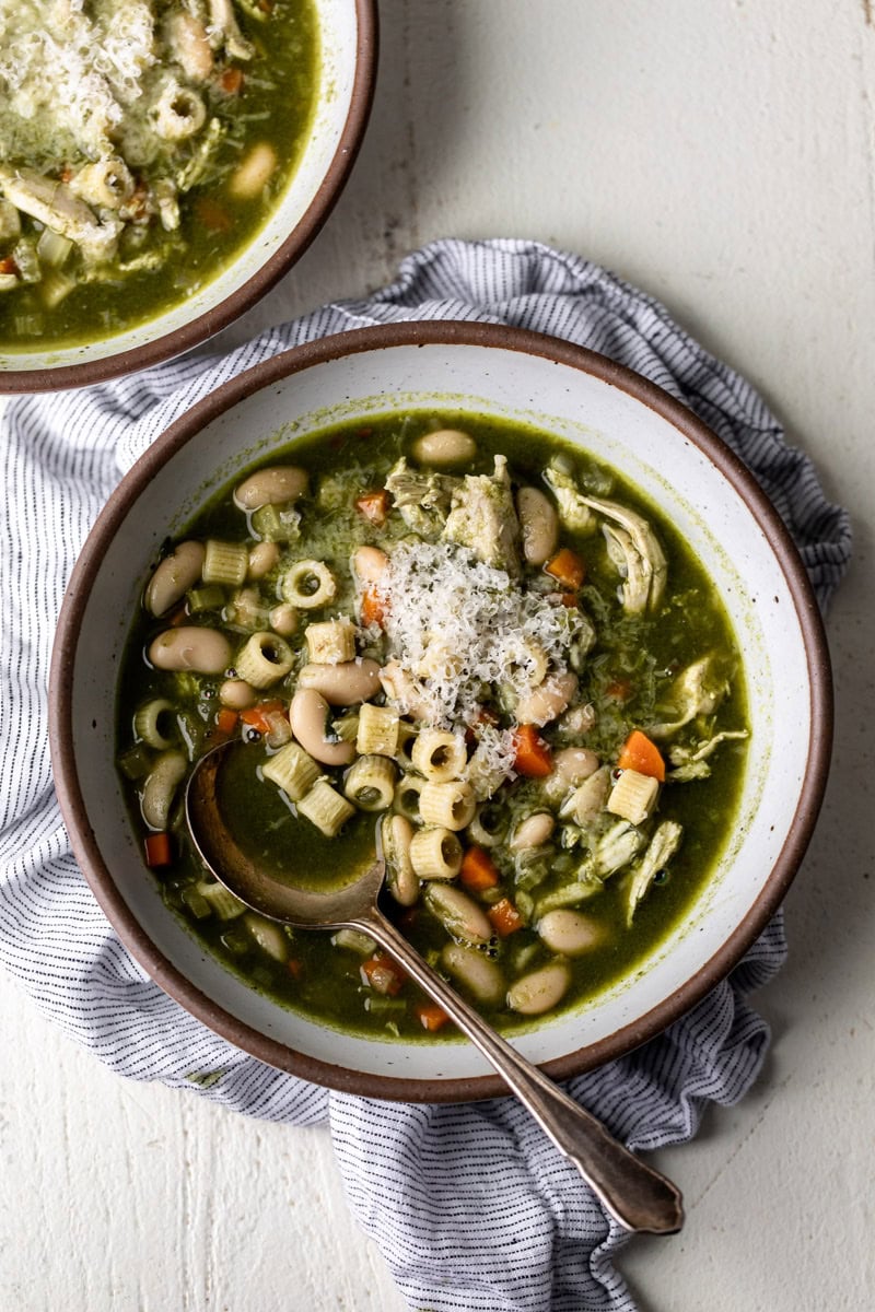 bowls of green minestrone soup.
