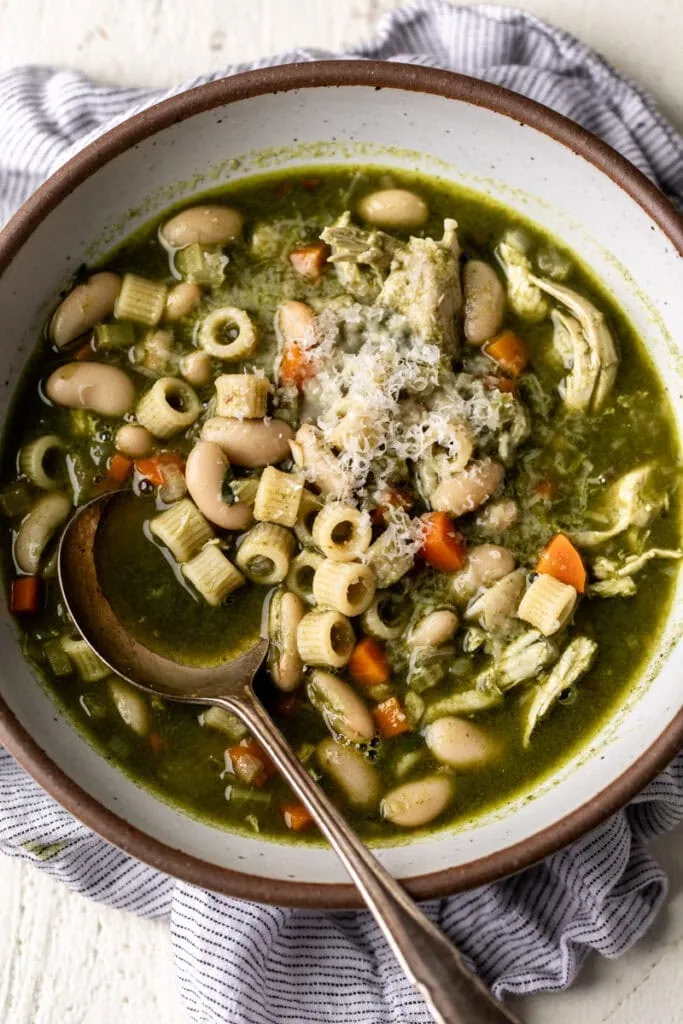 green minestrone soup with shredded chicken.