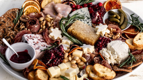 festive holiday cheese board with assorted cheese and charcuterie