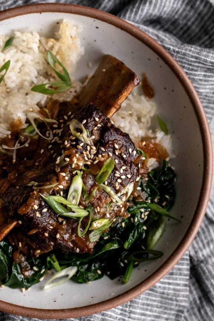 ginger miso braised bone-in short ribs with green onion over crispy rice.
