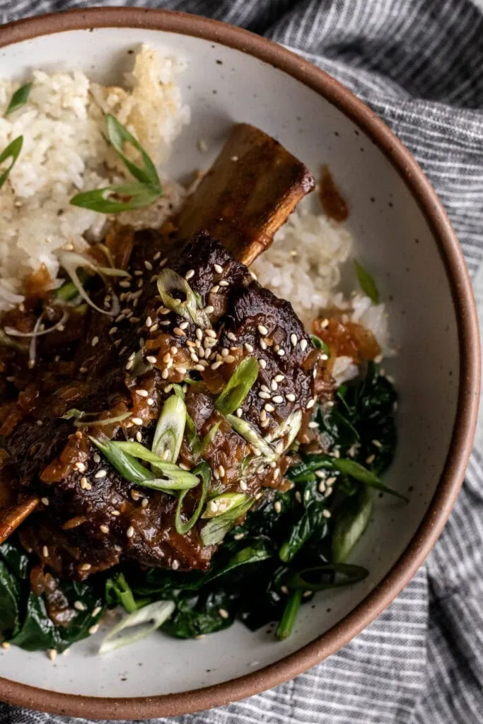 ginger miso braised bone-in short ribs with green onion over crispy rice.