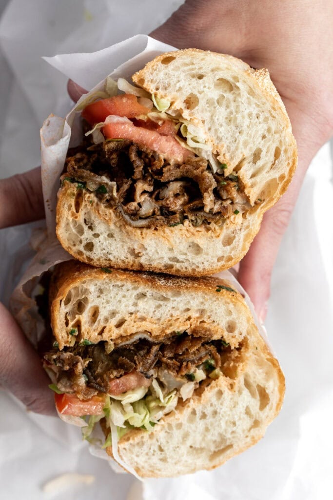 crispy oyster mushroom po boy with cajun remoulade cut in half.