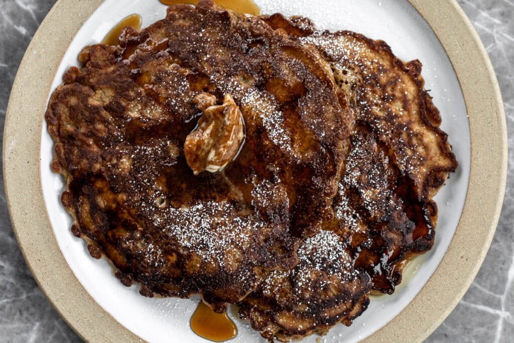 oatmeal griddle cakes with cinnamon butter and maple syrup.