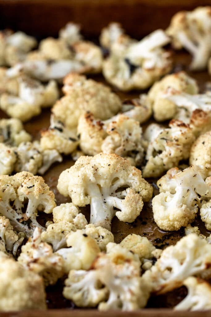 roasted Cauliflower florets on baking sheet.