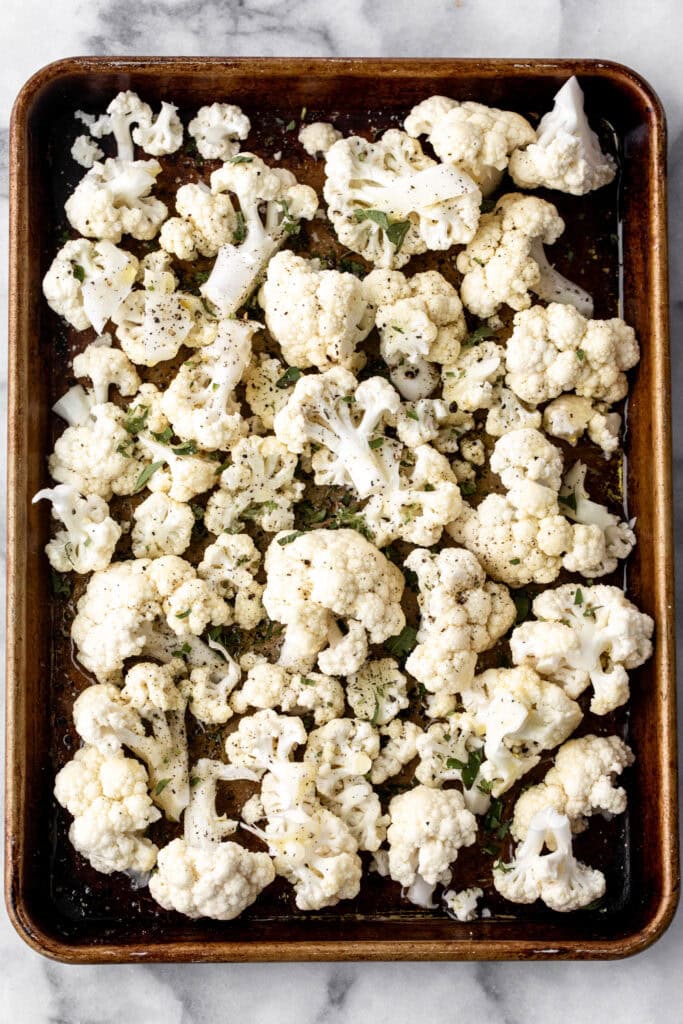 Cauliflower in a baking sheet for Roasted Cauliflower.
