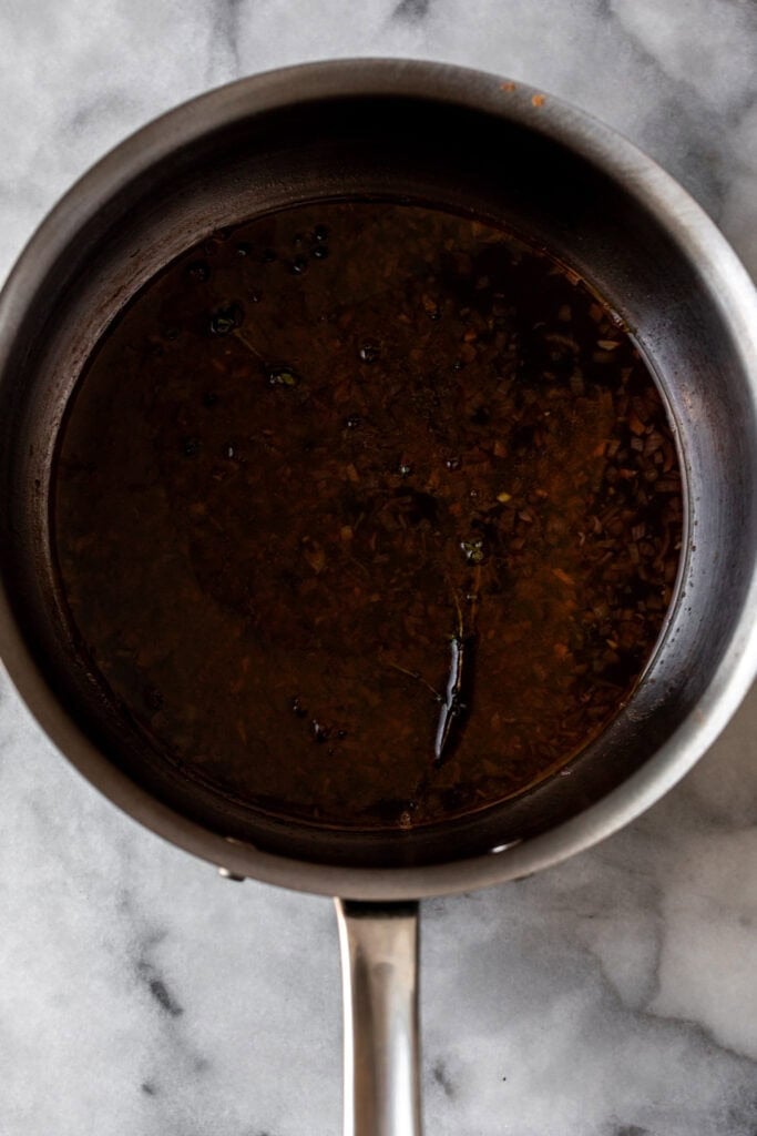 red wine reduction sauce in pan.