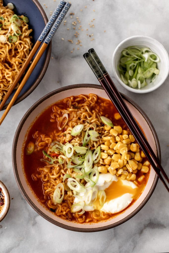 Store-Bought Instant Ramen Hacks - in photo: cooked ramen with egg and corn.