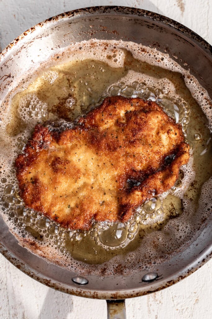 fried chicken for crispy chicken milanese cooked in pan.