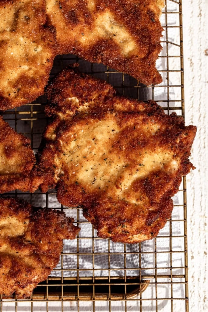 crispy chicken milanese on wire rack.