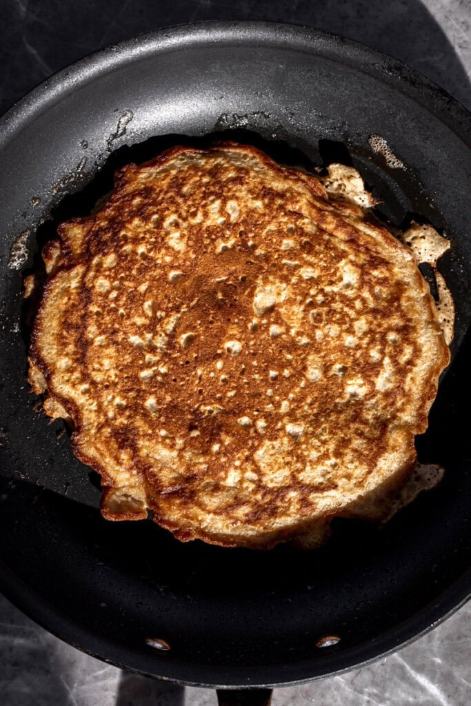 flipped pancake for Oatmeal Griddle Cakes.