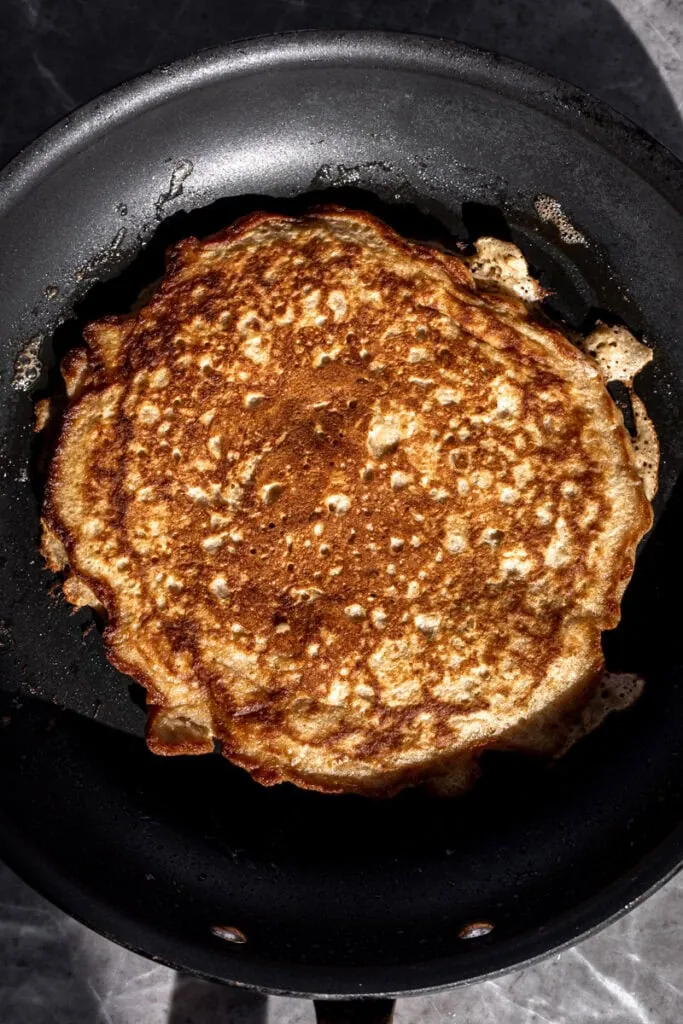 flipped pancake for Oatmeal Griddle Cakes