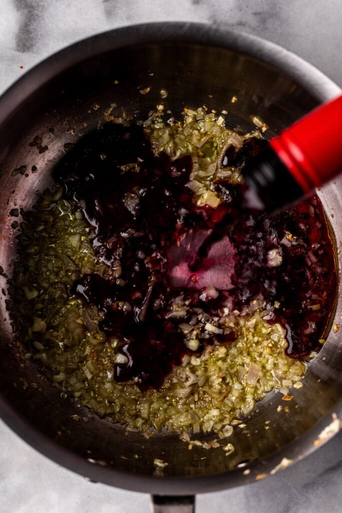 red wine reduction in pan.