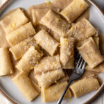 Simple creamy white bean and lemon pasta made with Paccheri noodles on plate.
