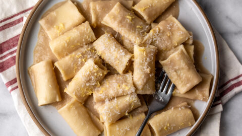 Simple creamy white bean and lemon pasta made with Paccheri noodles on plate.