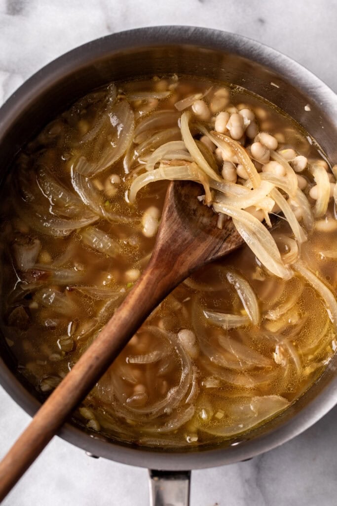Creamy White Bean and Lemon Pasta - in photo: beans and stock added to sautéed onion.