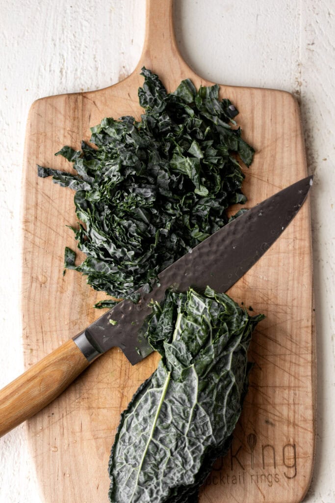 chopped kale on cutting board.