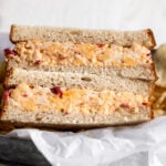 Southern pimento cheese sandwich on white bread cut in half.