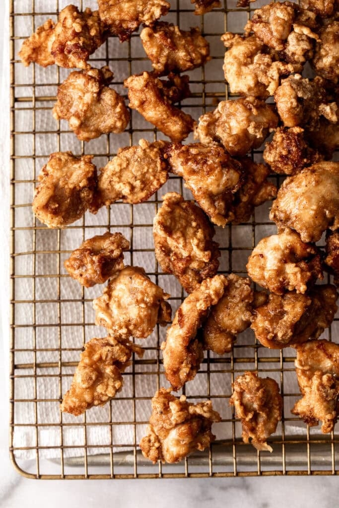 crispy fried chicken on wire rack.