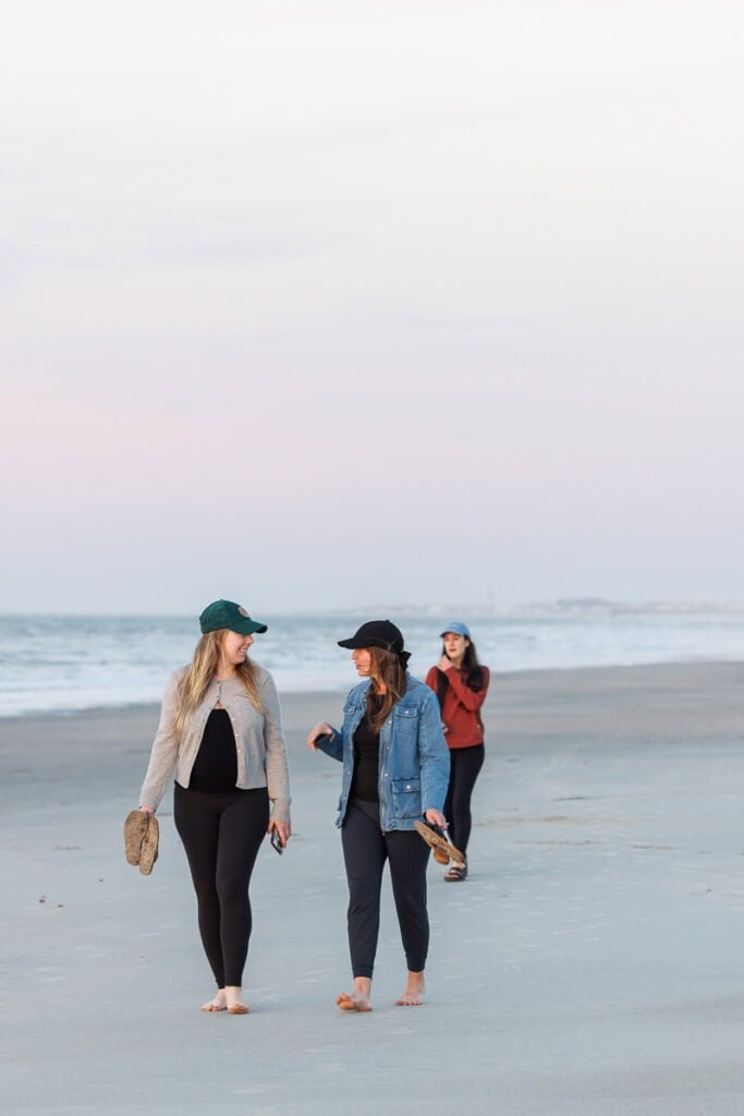 walking on beach at sunrise.