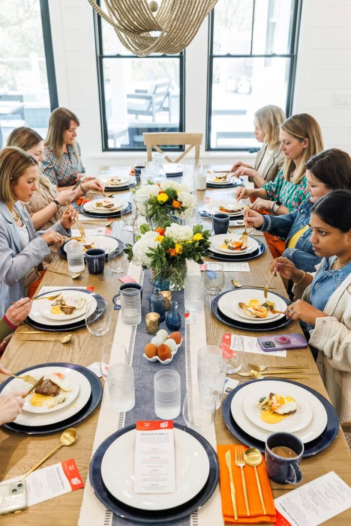 women sitting at table happy egg breakfast.