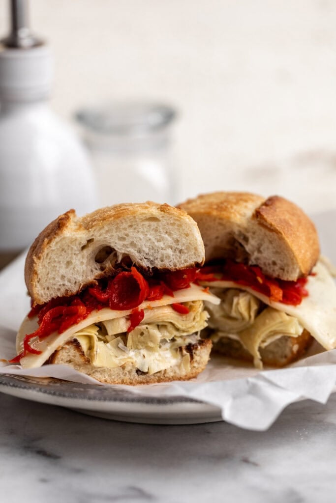 grilled artichoke sandwich with provolone cheese and red peppers on garlic bread.