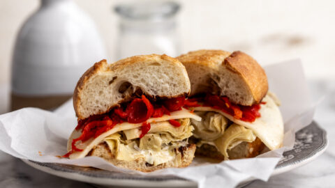 grilled artichoke sandwich with provolone cheese and red peppers on garlic bread.