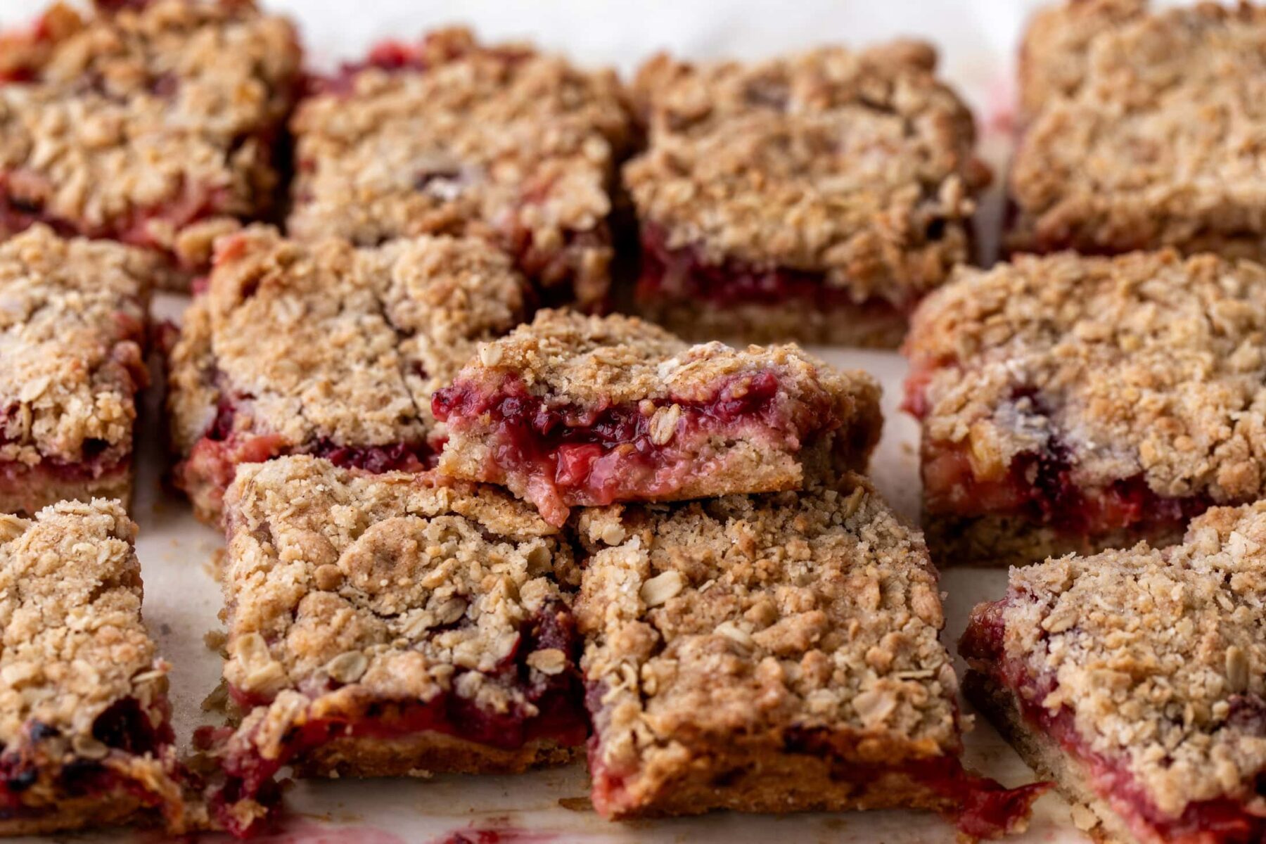 strawberry rhubarb crumble bars cut into squares.