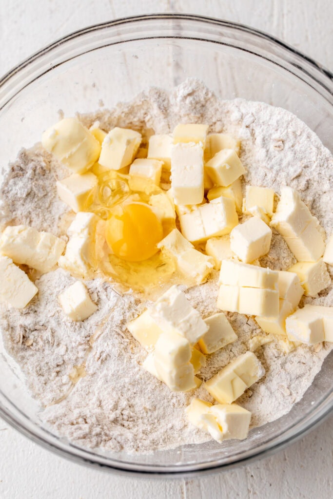 mixed oat crumble for strawberry Rhubarb Bars in glass mixing bowl.