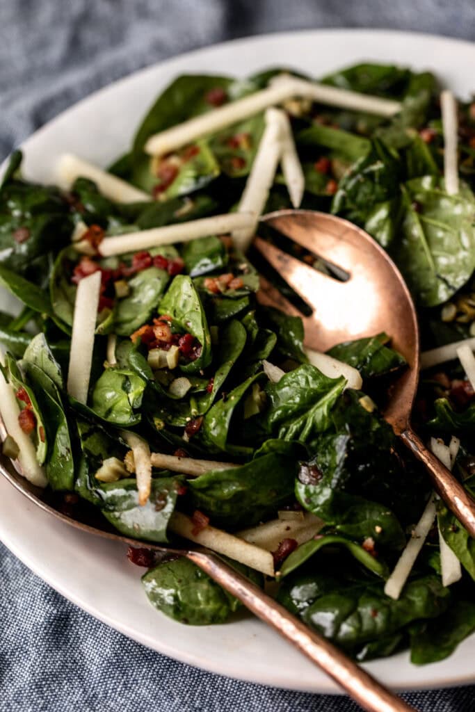 Warm Spinach Salad topped with pancetta and apples.