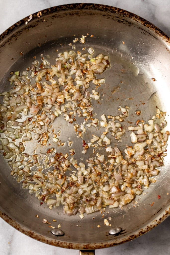 Sauté shallots in sauté pan for Warm Spinach Salad.