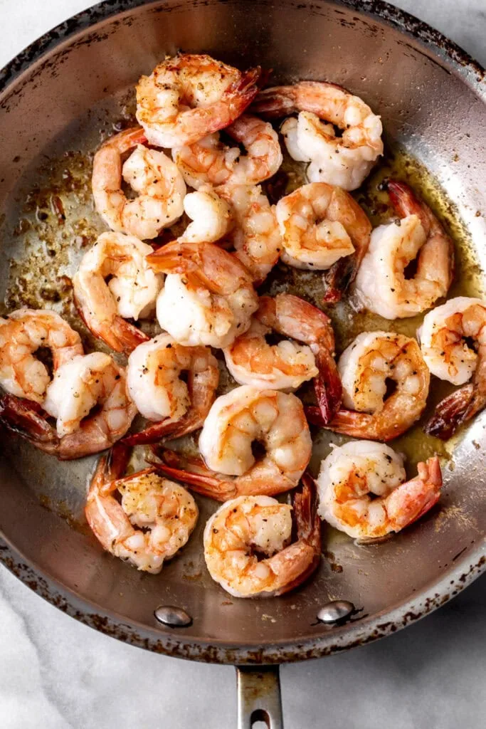 cooked shell-on shrimp in sauté pan.
