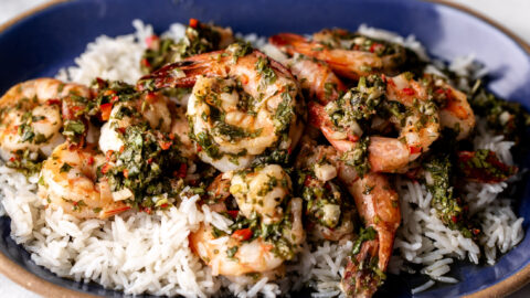 Chimichurri Shrimp with Coconut Rice on blue stone plate.