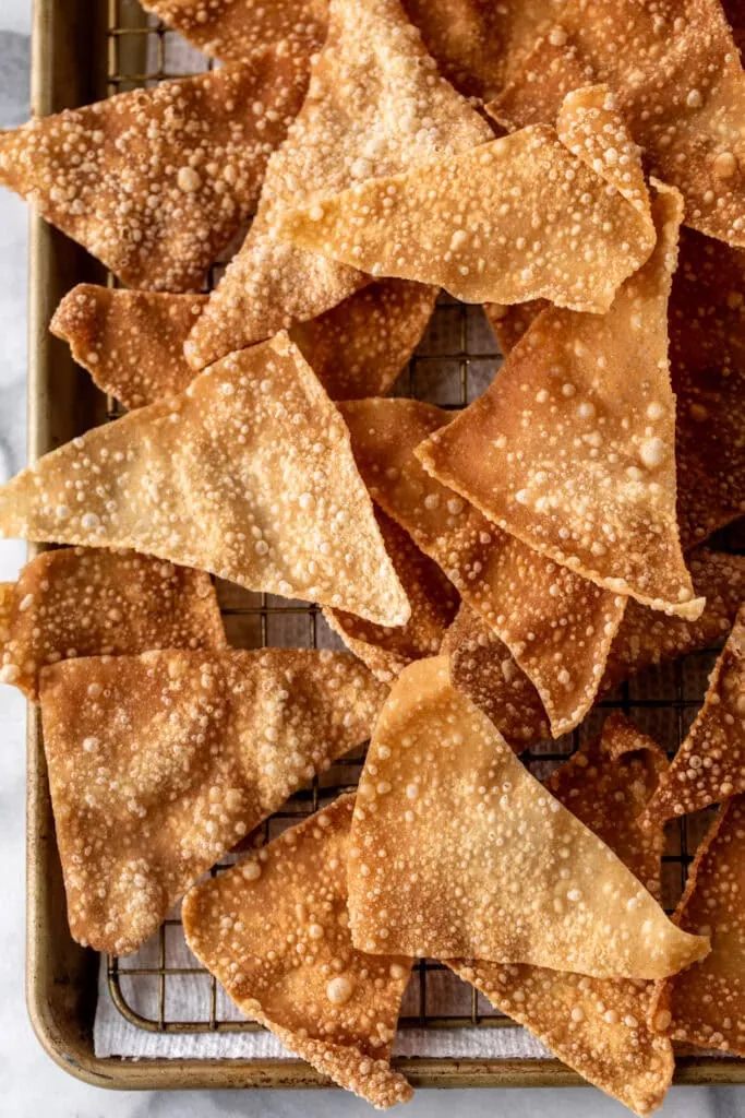 fried wontons drained on wire rack.