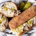 lemony tuna salad sandwich on baguette with pepperoncini.