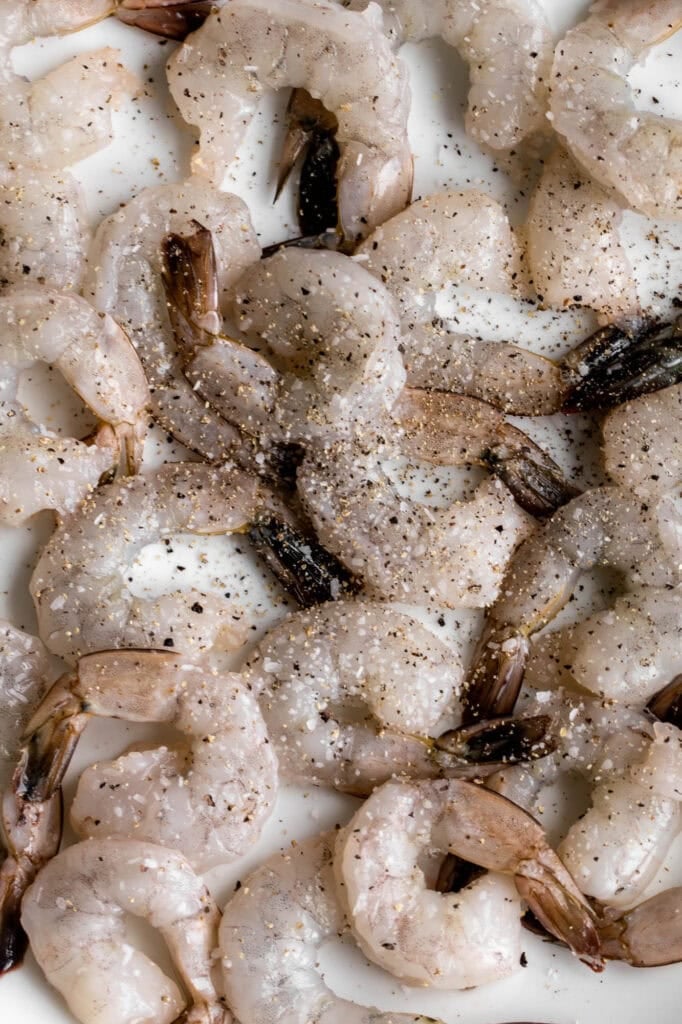 raw shrimp seasoned with salt and pepper.