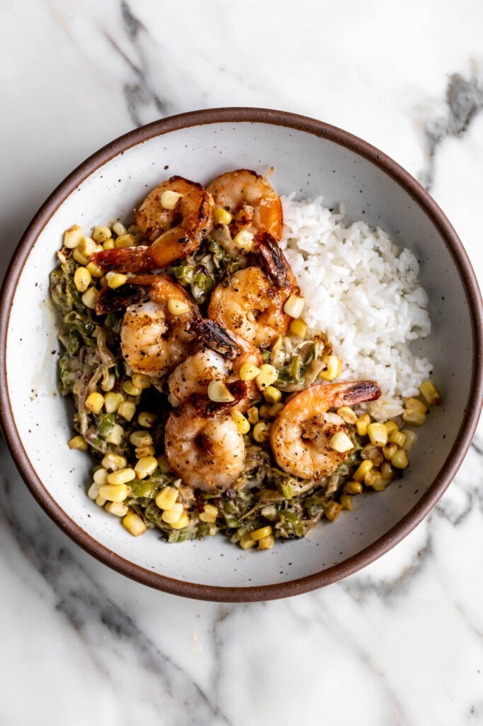 sautéed shrimp with shishitos and corn over rice.