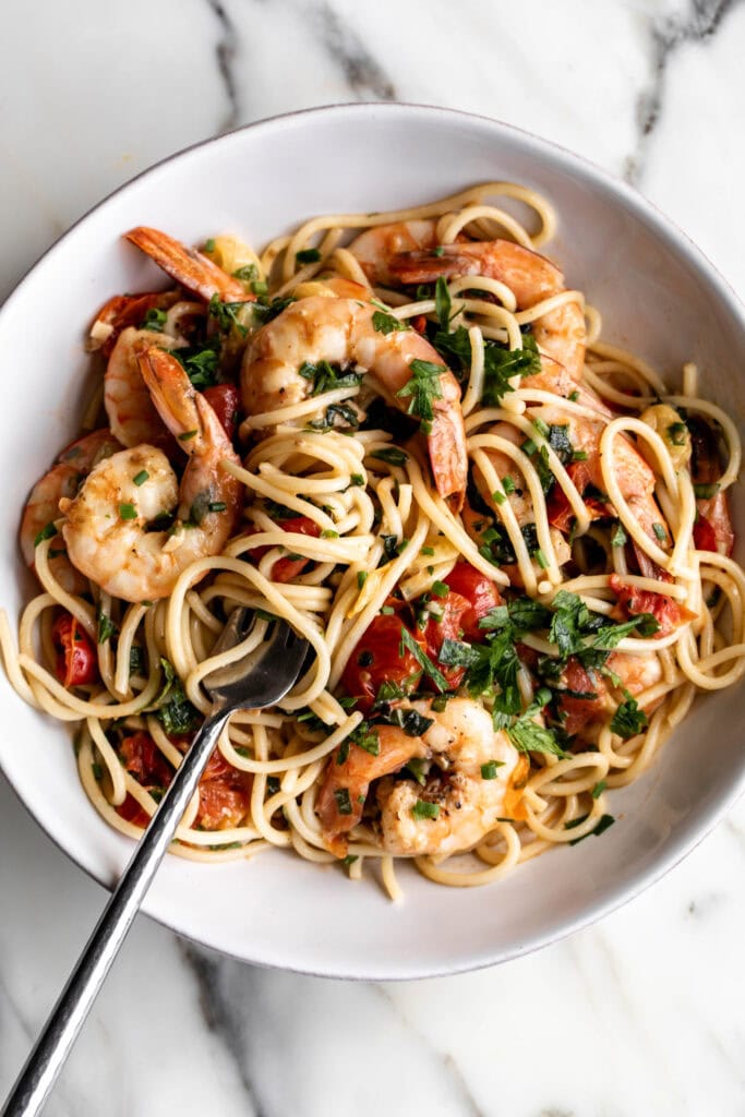 summer shrimp scampi pasta in white bowl.