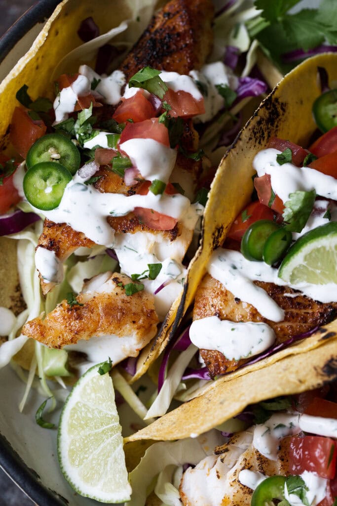 pan-seared fish tacos with pico de gallo and yogurt sauce.