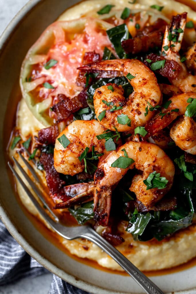 cajun shrimp and grits with bacon braised collard greens.