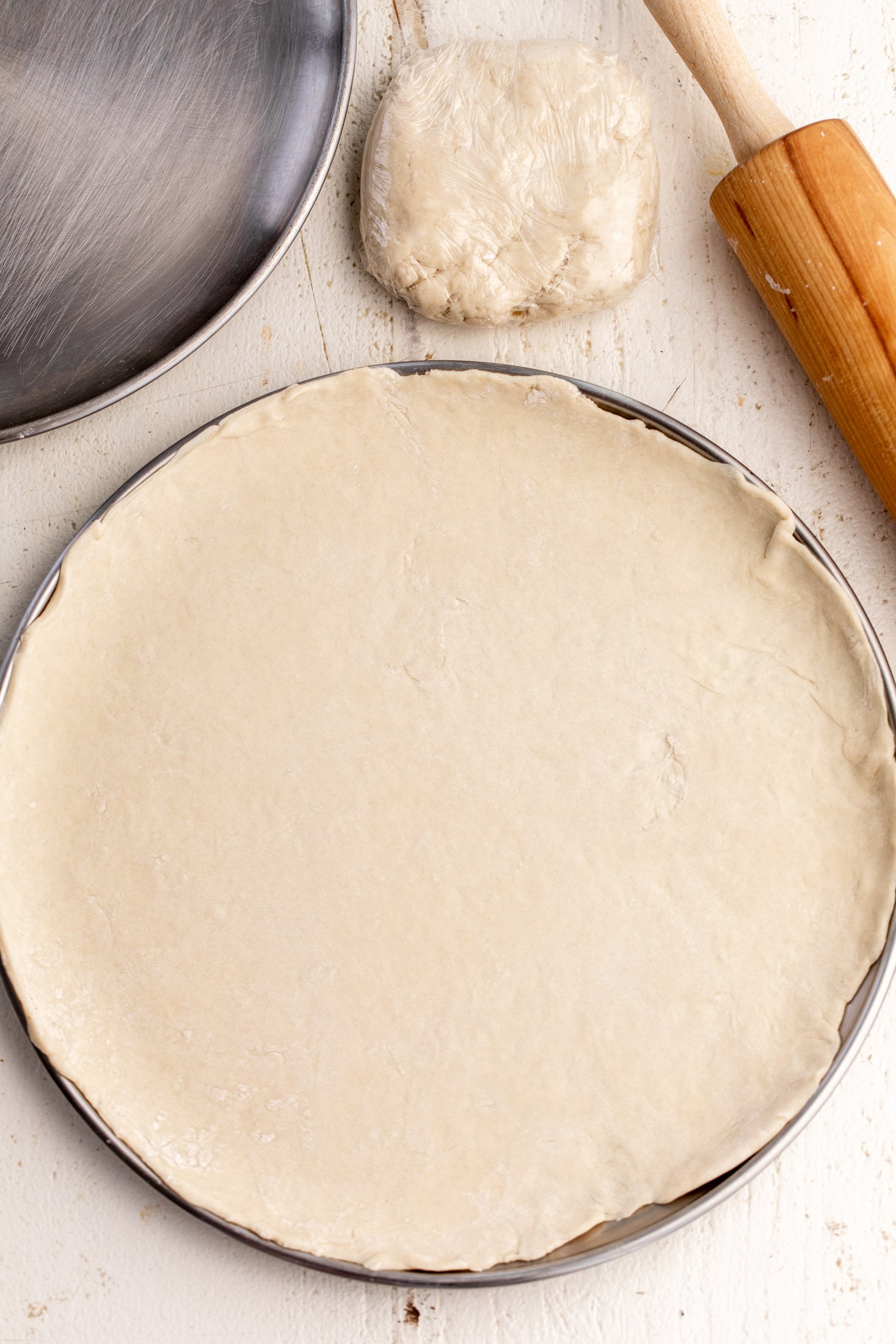 press and stretched pizza dough on pizza pan.