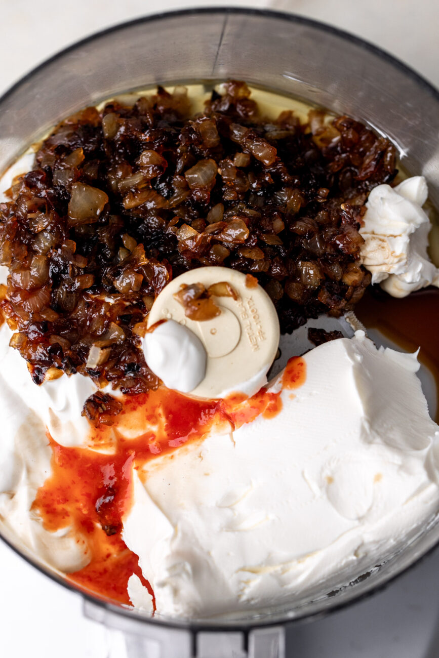 caramelized onions with cream cheese sour cream and ingredients in food processor.