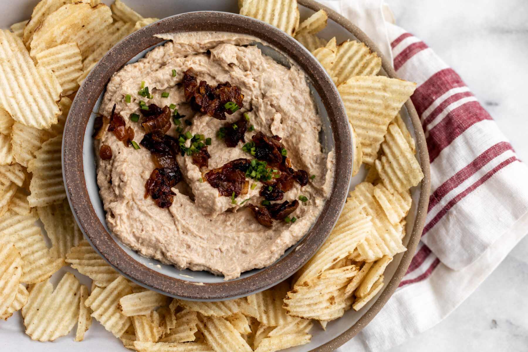sweet onion dip with caramelized onions and potato chips.