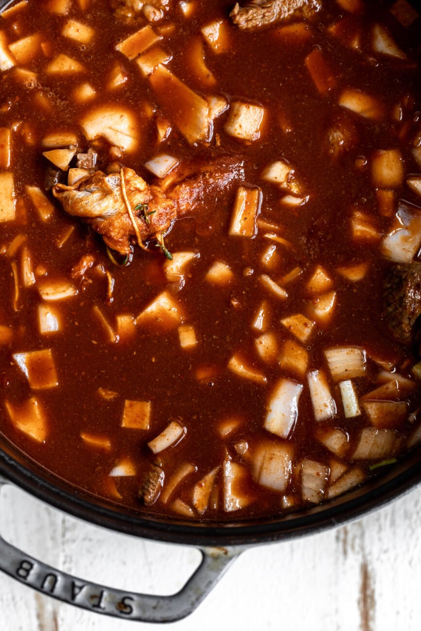 birria ingredients in dutch oven ready for braise.