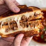 birria grilled cheese pulled open with consommé for dipping.
