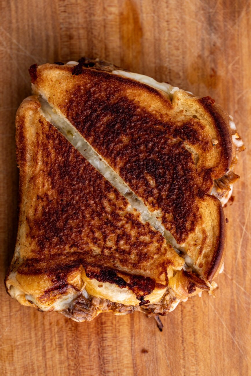 halved birria grilled cheese sandwich.