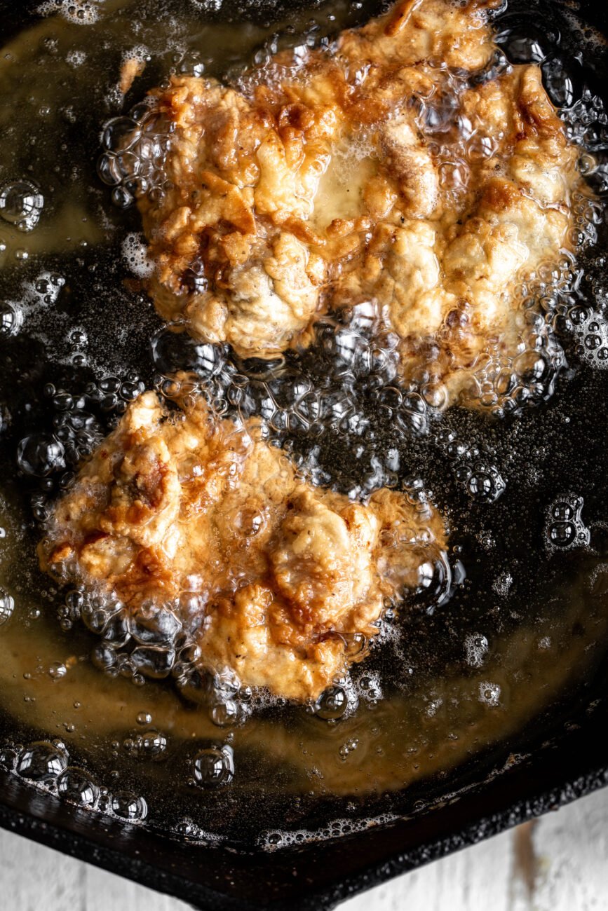 fried boneless chicken thights in oil.
